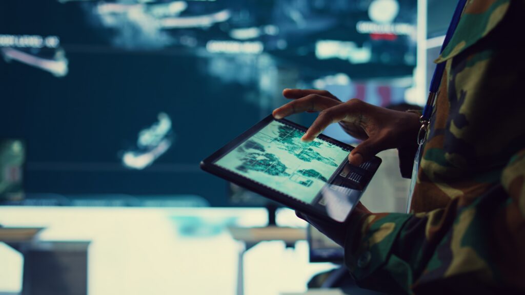 Army soldier reviews target satellite world map