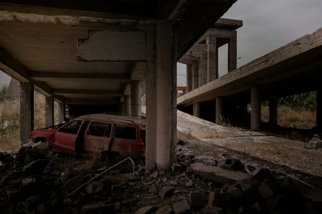 Wrecked car and other destruction at an unfinished building in Mosul, following war with the Islamic State.