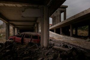 Wrecked car and other destruction at an unfinished building in Mosul, following war with the Islamic State.